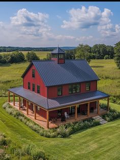 an aerial view of a red house in the middle of a field