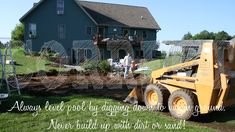 a yellow bulldozer parked in front of a house with people standing around it