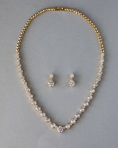 An everyday special occasion necklace style perfect for the bride or any time! Two sizes of brilliant-cut cubic zirconia alternate with small round jewels to create this spin on a classic necklace style! The length of the necklace is 17 inches and the length of the pierced earrings is .75 inches. This set is rhodium, rose gold, or gold plated with grade AAA CZ stones and is lead, cadmium, and nickel free. Modern Indian Jewelry Necklaces, Elegant Gold Necklace Set, 15 Jewelry Set, Gold And Diamond Necklace Set, Gold Jewelry Diamond, Elegant Gold Jewelry Set, Small Stone Earrings Gold, Gold Jewelry With Diamonds, Round Gold Necklace