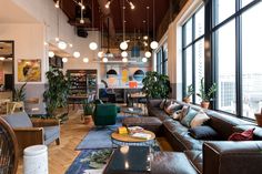 a living room filled with furniture and lots of windows