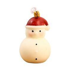 a white ceramic ornament with a red santa hat on it's head