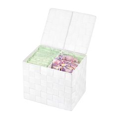 a white box filled with lots of pink and green tissue paper on top of a white surface