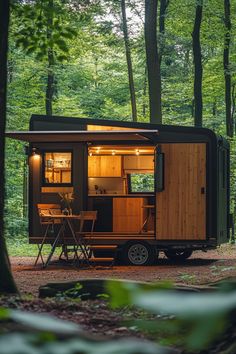 a tiny house in the middle of a forest with lights on it's windows