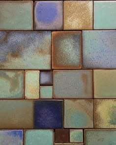 a close up view of some tiles with different colors and shapes on it's surface