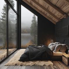 a large bed sitting under a window on top of a wooden floor next to a wall