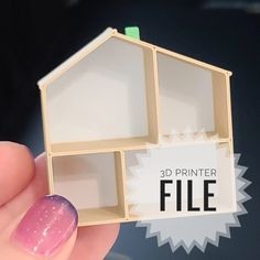 a miniature house made out of plexed wood with pink and purple nail polish