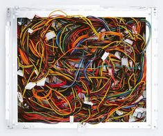 an assortment of colorful wires in a white box