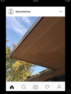 an instagram photo of a house with the roof up and trees in the background