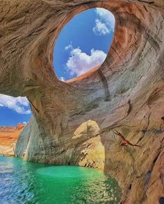 an image of the inside of a rock formation with water in it and sky above