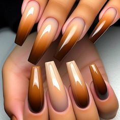 Long, coffin-shaped nails with an ombre gradient from a light caramel brown at the cuticle to a dark chocolate brown at the tips. The transition is smooth and seamless, creating a delicious gradient effect. The nails have a glossy top coat for added shine. Fall Inspired Nails Square, Pedicure Ideas Brown Skin, Nail Designs Brown Color, Chocolate Brown Fall Nails, Gel Ombré Nails, Fall Nails And Toe Nails, Ombre Fall Nail Colors, Brown And Orange Ombre Nails, Shades Of Brown Nail Designs