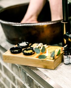 a wooden tray topped with lots of food