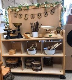 an old fashioned store display with various items on it's shelves, including bowls and spoons