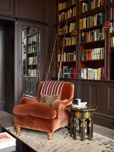 a living room filled with lots of books and furniture