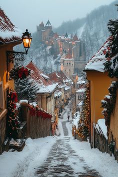 a snowy street lined with houses and trees covered in christmas lights, surrounded by snow