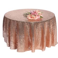 a round table covered in gold sequins with flowers on the top and bottom