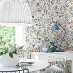 an image of a room with floral wallpaper on the walls and chairs in front of it