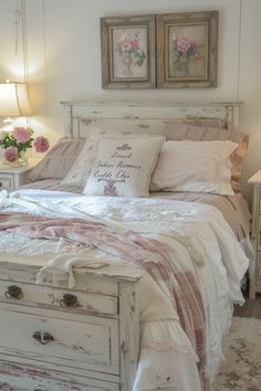 a white bed sitting next to two lamps on either side of it