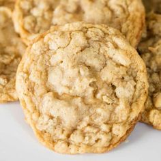 several cookies on a white plate with one cookie in the middle and two oatmeal cookies to the side