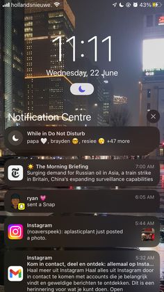 an iphone screen showing notifications in the city at night with buildings and skyscrapers