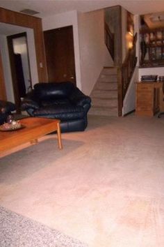 a living room filled with furniture and a stair case