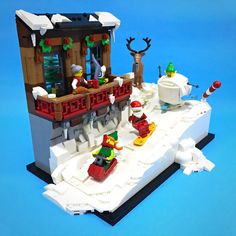 a lego christmas scene with santa's sleigh and reindeer on the roof