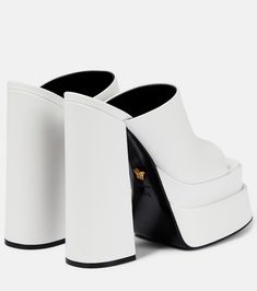 Leather platform mules in white - Versace | Mytheresa Luxury White Mules With Sculpted Heel, Modern White Mules With Sculpted Heel, Luxury Leather Platform Slides, White Square Toe Mules With Branded Heel, Luxury Slides With Platform And Round Toe, White Platform Heels With Square Toe, White Square Toe Platform Sandals, White Luxury Formal Mules, White Open Toe Platform Mules