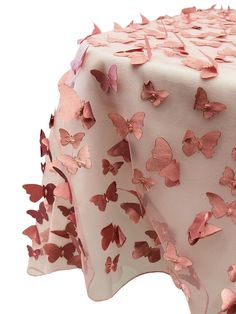 a pink table cloth with butterflies on it