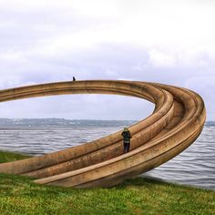 a man standing on top of a giant wooden boat