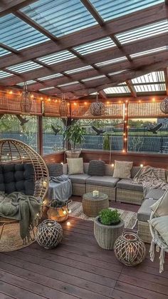 an outdoor living area with wicker furniture and string lights