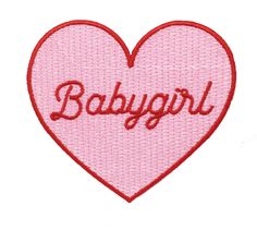 a pink heart with the word baby girl in red embroidery on it's side