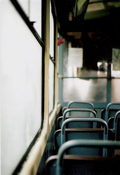 rows of empty seats on a public transit bus, taken from inside the vehicle door