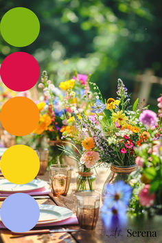 the table is set with colorful plates and vases filled with flowers on each plate