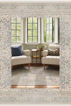 a living room with two chairs and a table in front of a window that has floral wallpaper on it