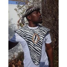 Our authentic Zulu warrior 2 in 1 outfit is handmade in South Africa by a speciliast Zulu warrior crafter.  The Zulu warrior outfit consists of 2 pieces namely:  Mbata or isipango (Chest and back cover) are made of fabric printed it out with zebra patterns but the trimmings are made of springbok skin, Umqhele made of real cowskin (Headband)  The Zulu (also amaZulu, means "sky") are an African ethnic group of the Bantu with more then eleven million people and the largest ethnic group in South Africa.  They live mainly in the South African province of KwaZulu-Natal.  The language of the Zulu is isiZulu. The outfits are One size fits all.  Adjustable. A truly magnificent gift for your life partner or Father. This item will also be shipped express via DHL and we can guarantee swift delivery. W Shaka Zulu, Wedding Attire For Women, Zulu Warrior, Warrior Outfit, Warrior 2, Ceremony Wedding, Traditional Fabric, African Men, Zulu