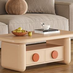 a coffee table with some fruit on it and a bowl of apples in the middle