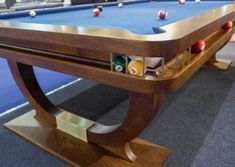 a pool table with several billiards on it in a room filled with blue carpeted flooring