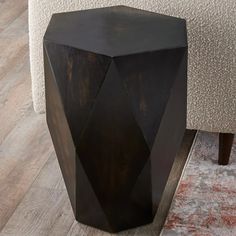 a wooden table sitting on top of a floor next to a chair