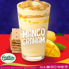 an advertisement for a fruit drink with mango and graham crackers on the table next to it