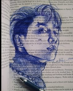 an open book with a drawing of a man's face