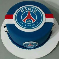 a paris saint - germain cake with blue and white frosting on a round plate