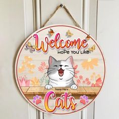 a welcome sign hanging on the front door of a house with a cat saying,'welcome hope you like cats '