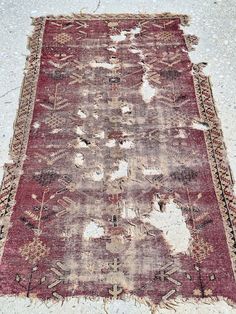 an old rug is laying on the ground