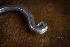 a close up of a metal object on a wooden table