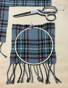 a pair of scissors sitting on top of a table next to a piece of fabric