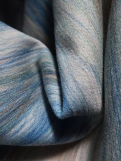 a close up view of a blue and grey scarf