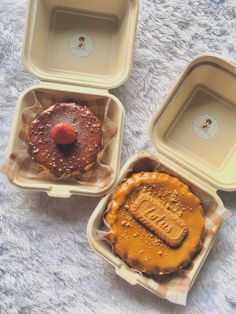 three plastic containers filled with food on top of a white table covered in furnishing