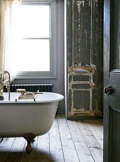 an old fashioned bath tub in front of a window