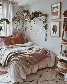 a bedroom with white walls and plants on the wall