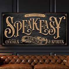 a sign that says speakeasy lounge and spirits on the wall above a couch