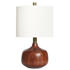 a wooden table lamp with a white shade